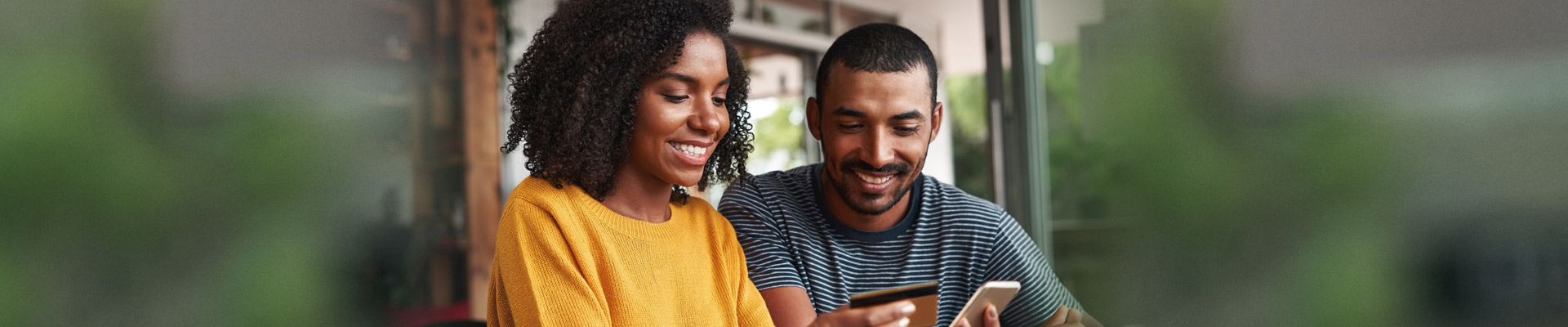 Young woman and man with phone